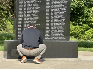 Veteran praying at the GWOT Memorial