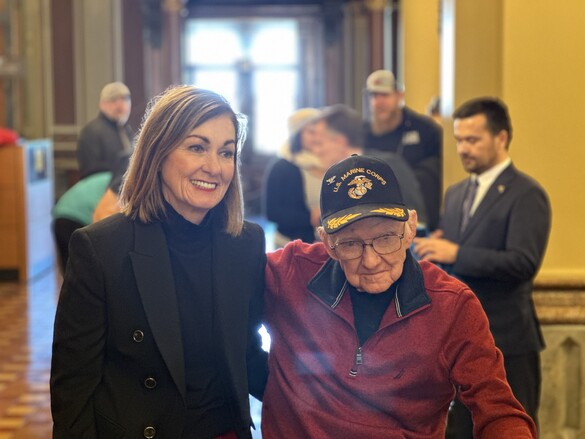 Iowa Gov. Kim Reynolds with the oldest Marine present, Lyle Holmes.